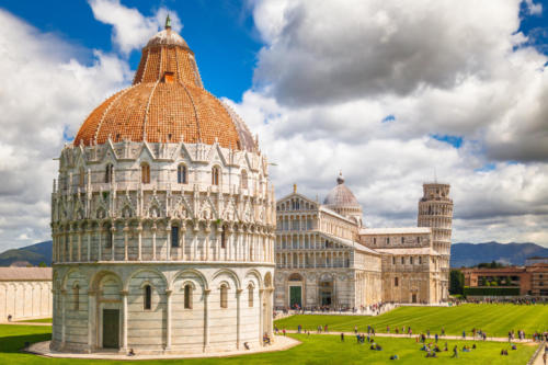 The Pisa Baptistery of St. John, The Cathedral and The Leaning Tower of Pisa in Square of Miracles at sunny day, Tuscany region, Italy.